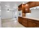 Open concept kitchen features tile flooring, wooden cabinets, and white appliances at 3022 Blackhawk St, Aurora, CO 80011