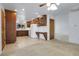 Bright kitchen with tile floors, wooden cabinets and built-in desk area at 3022 Blackhawk St, Aurora, CO 80011