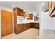 Kitchen features wooden cabinets, tile floors, white oven, and window at 3022 Blackhawk St, Aurora, CO 80011