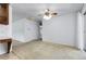 A carpeted living room features white walls, ceiling fan, and natural light at 3022 Blackhawk St, Aurora, CO 80011