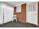Relax on screened-in patio area with exposed brick, outdoor seating and privacy curtains at 3022 Blackhawk St, Aurora, CO 80011