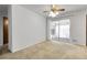 An enclosed sun room features white walls, sliding glass door and carpet at 3022 Blackhawk St, Aurora, CO 80011