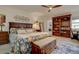 Main bedroom with a floral comforter, ceiling fan, and built-in shelving at 2752 S Heather Gardens Way, Aurora, CO 80014