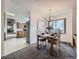 Cozy dining area with a table set for four, natural light, and connecting kitchen view at 7016 Reed St, Arvada, CO 80003