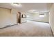 Finished basement living room with neutral carpet and an arched entry at 7016 Reed St, Arvada, CO 80003