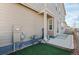 Backyard featuring artificial turf, concrete patio, and the house's utilities at 21210 E Radcliff Pl, Aurora, CO 80015