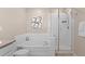 Cozy bathroom featuring a soaking tub, shower, and neutral-colored tile flooring at 21210 E Radcliff Pl, Aurora, CO 80015