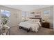 Beautiful bedroom with many windows, carpet, and neutral décor with a comfortable king bed at 21210 E Radcliff Pl, Aurora, CO 80015