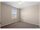 Empty bedroom featuring neutral walls, carpet, and window at 21210 E Radcliff Pl, Aurora, CO 80015
