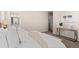 Relaxing bedroom features a large bed, and an open door to a bathroom at 21210 E Radcliff Pl, Aurora, CO 80015