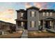 Two-story home with a welcoming front porch, neutral-tone siding, and stylish shutters at 21210 E Radcliff Pl, Aurora, CO 80015