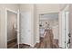 Hallway offering views into half bath and open concept floor plan with an easy flow to the dining area at 21210 E Radcliff Pl, Aurora, CO 80015