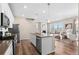 Modern kitchen featuring an island, stainless steel appliances, and a seamless flow to the living area at 21210 E Radcliff Pl, Aurora, CO 80015