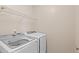 Convenient laundry room equipped with modern Samsung washer and dryer units and built-in shelving at 21210 E Radcliff Pl, Aurora, CO 80015