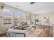 Inviting living room area, bright windows, hardwood floors, and adjacent dining space at 21210 E Radcliff Pl, Aurora, CO 80015