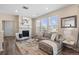 Bright living room with fireplace, large windows, and modern gray sectional sofa at 21210 E Radcliff Pl, Aurora, CO 80015