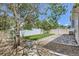 Backyard featuring a stone patio, green lawn, rock features, mature tree, and a privacy fence at 18807 E 51St Pl, Denver, CO 80249