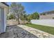 Well-maintained backyard featuring a stone patio, green lawn, and privacy fence at 18807 E 51St Pl, Denver, CO 80249