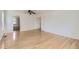 Spacious bedroom with hardwood floors, white walls, and access to an ensuite bathroom and closet at 18807 E 51St Pl, Denver, CO 80249