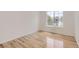 Bright bedroom featuring hardwood floors and a large window offering natural light at 18807 E 51St Pl, Denver, CO 80249
