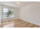Bright bedroom featuring hardwood floors and a large window offering natural light at 18807 E 51St Pl, Denver, CO 80249