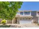 Charming two-story home featuring stone accents, blue shutters, and a well-manicured front yard at 18807 E 51St Pl, Denver, CO 80249