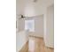 Hallway with hardwood floors, a modern ceiling fan and a unique block window at 18807 E 51St Pl, Denver, CO 80249