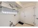 Functional laundry room with shelving, storage space, and natural light through a window at 18807 E 51St Pl, Denver, CO 80249