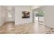 Bright living room boasts beautiful wood flooring, large sliding glass doors, and open concept to kitchen at 18807 E 51St Pl, Denver, CO 80249