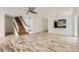 Bright living room boasts beautiful wood flooring, staircase and open concept to kitchen at 18807 E 51St Pl, Denver, CO 80249