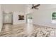 Bright living room boasts beautiful wood flooring, large windows, and open concept to kitchen at 18807 E 51St Pl, Denver, CO 80249