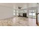 Inviting living room with wood floors, fireplace, and sliding glass doors providing natural light at 18807 E 51St Pl, Denver, CO 80249