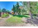 Lush backyard offers a serene retreat with a well-manicured lawn, mature trees, and a charming garden at 6971 S Valentia St, Centennial, CO 80112