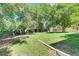 Expansive backyard showcases a large, well-kept lawn, mature trees, and a fenced perimeter for privacy at 6971 S Valentia St, Centennial, CO 80112