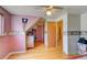 Bright bedroom features hardwood floors, ceiling fan, and a unique decorative border for a cozy and inviting space at 6971 S Valentia St, Centennial, CO 80112