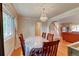 Bright dining area with hardwood floors, a chandelier, and staircase at 6971 S Valentia St, Centennial, CO 80112