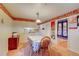 Bright dining area with laminate floors offering views into kitchen at 6971 S Valentia St, Centennial, CO 80112
