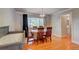 Bright dining area with hardwood floors, a chandelier, and crib in the corner at 6971 S Valentia St, Centennial, CO 80112