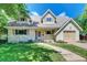 Charming home featuring dormer windows, a well-kept lawn, and an attached one-car garage at 6971 S Valentia St, Centennial, CO 80112