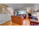 Cozy living room with hardwood floors, a decorative fireplace, and comfortable leather seating at 6971 S Valentia St, Centennial, CO 80112