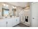 This bright bathroom offers dual sinks, a glass enclosed shower, and modern fixtures for a spa-like experience at 4853 Cattle Cross Ln, Castle Rock, CO 80104