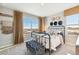 This cozy bedroom features a metal bed frame, and large windows offering a scenic view at 4853 Cattle Cross Ln, Castle Rock, CO 80104