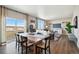 Open-concept dining area features a rustic table, views, and seamless flow into the adjacent living space at 4853 Cattle Cross Ln, Castle Rock, CO 80104