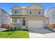 Charming two-story home with a well-manicured lawn, covered front porch, and attached two-car garage at 4853 Cattle Cross Ln, Castle Rock, CO 80104