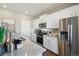 Bright kitchen with white cabinets, granite countertops, stainless steel appliances, and modern fixtures at 4853 Cattle Cross Ln, Castle Rock, CO 80104