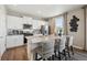 Bright kitchen with white cabinets, granite countertops, stainless steel appliances, and modern fixtures at 4853 Cattle Cross Ln, Castle Rock, CO 80104