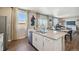 Bright open-concept kitchen with a center island, granite countertops, stainless steel appliances, and modern fixtures at 4853 Cattle Cross Ln, Castle Rock, CO 80104