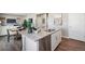 Bright open-concept kitchen with a center island, granite countertops, stainless steel appliances, and modern fixtures at 4853 Cattle Cross Ln, Castle Rock, CO 80104