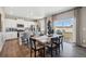 Open-concept kitchen and dining area with stainless steel appliances, a center island, and hardwood floors at 4853 Cattle Cross Ln, Castle Rock, CO 80104