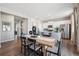 Open-concept kitchen and dining area with stainless steel appliances, a center island, and hardwood floors at 4853 Cattle Cross Ln, Castle Rock, CO 80104